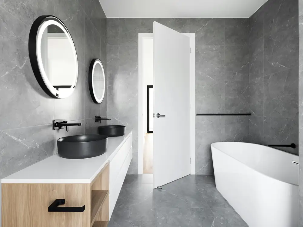 Large-format stone-look tile floor in a finished bathroom