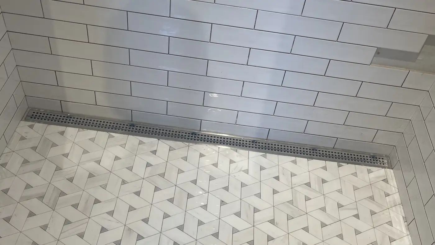 Marble mosaic shower floor with a linear drain